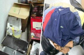 Zaplenjena veća količina firmirane garderobe, električnih aparata i alata