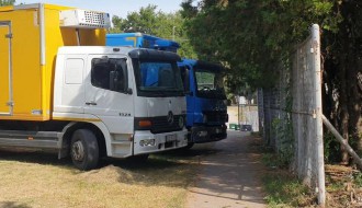 Kamioni na zelenoj površini i pešačkoj stazi u Aleksandrovu